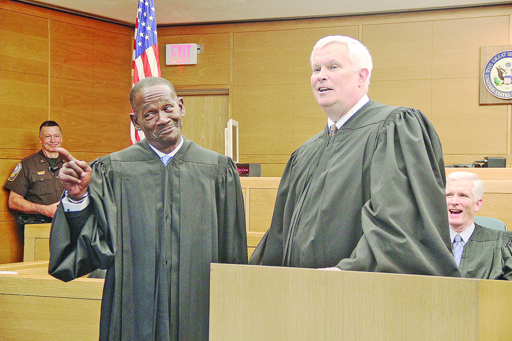 Judge Onzlee Ware (left) gestures to the crowd during Judge Charles Dorsey’s closing remarks.